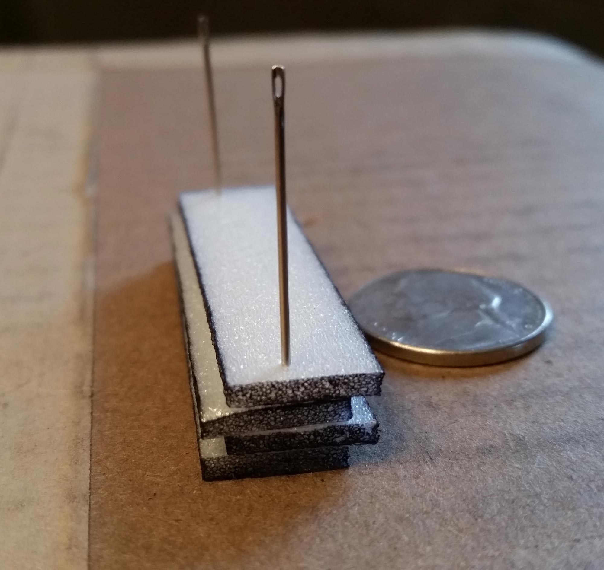 Stack of four foam strips pinned in place.