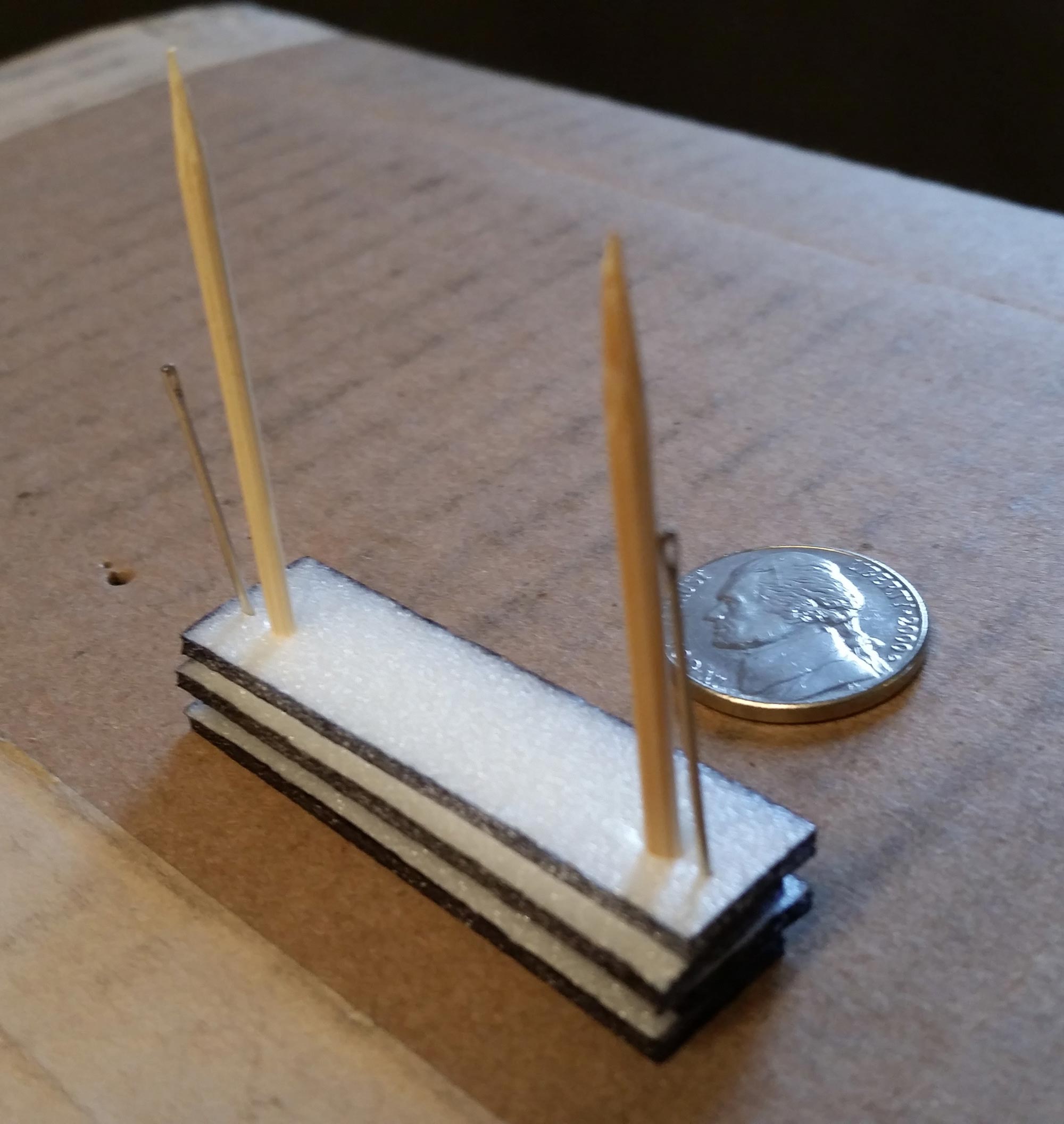 Toothpicks pushed through the foam strips.