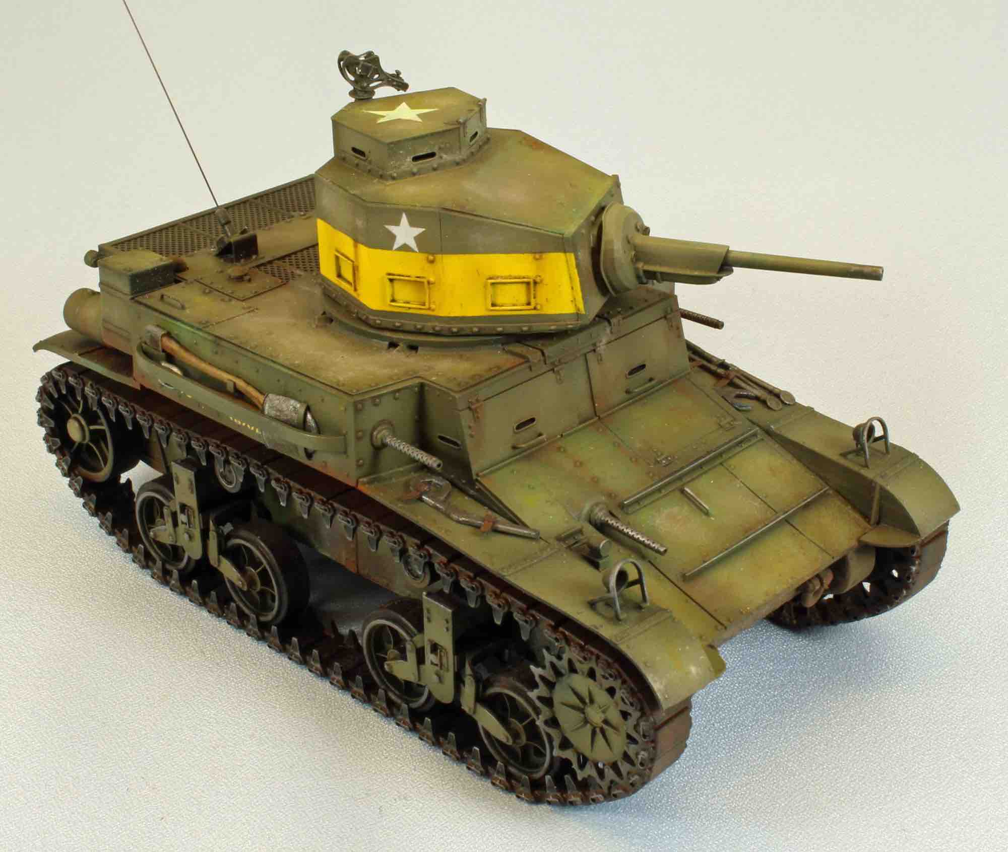 M2A4 light tank with pale yellow and concrete pigments breaking up the olive-drab finish.
